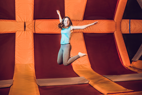 Young supermodel in a room full of trampolines